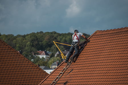 man climbing on roof at daytime thumbnail