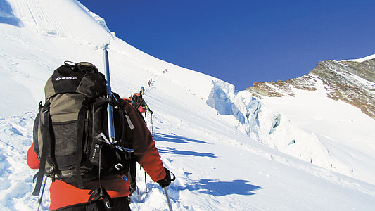 man trekking snow covered mountain thumbnail