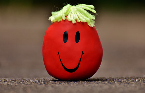 red smiley rock decor on grey floor thumbnail