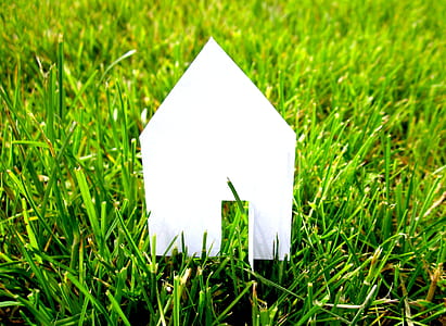 white paper house on green grass thumbnail