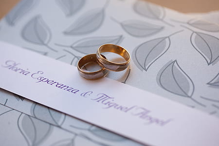 pair of gold-colored rings on cloth thumbnail
