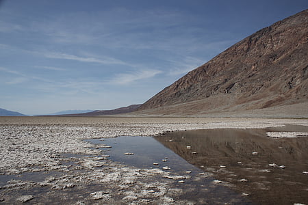 brown hill near body of water at daytime thumbnail