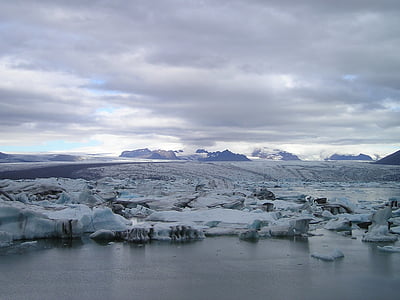 field covered with snow near body of water under white and gray skies at daytime thumbnail