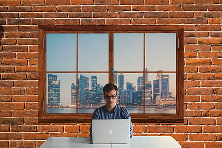 man in front of silver MacBook thumbnail