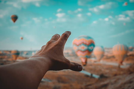 person reaching his left hand on air balloons thumbnail