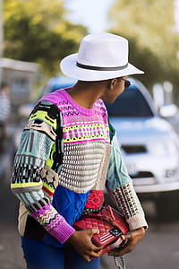 Woman Wearing White Hat Holding Red Handbag thumbnail
