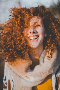 Woman Wearing Gray Knitted Scarf While Smiling thumbnail