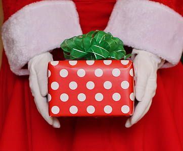 person holding red and white polka-dot gift box thumbnail