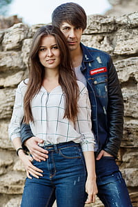 man holding women's hips infront of wall thumbnail