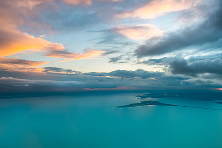 island surrounded by body of water under daytime sky thumbnail