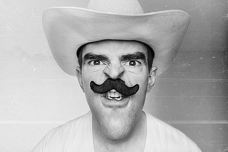 grayscale photography of man in cowboy hat with mustache thumbnail