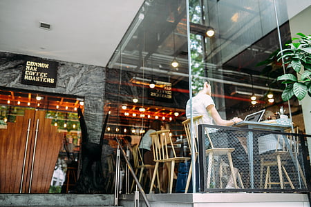 person sitting in front of table using laptop computer thumbnail