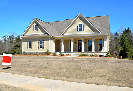 yellow and gray painted house near plants thumbnail