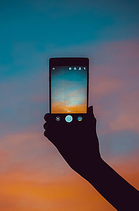 person holding phone using camera application thumbnail