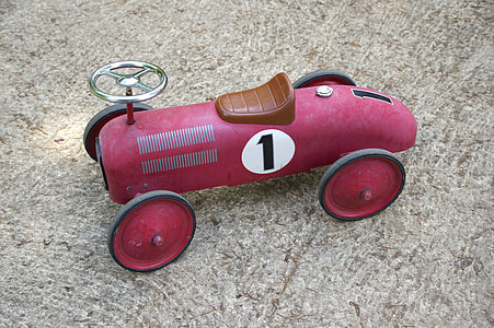 red and black ride-on toy on gray surface thumbnail