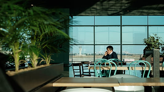 man using phone in front of table thumbnail