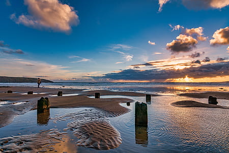 beach shore under blue and white sky thumbnail