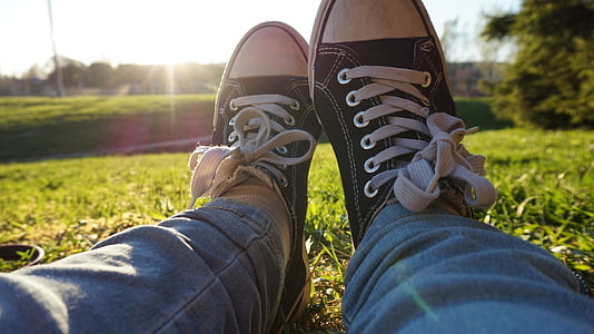 closeup photography of person wearing pair of black-and-white low-top sneakers thumbnail
