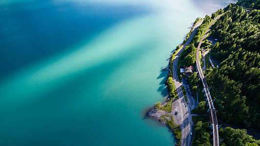 aerial view of road near body of water thumbnail