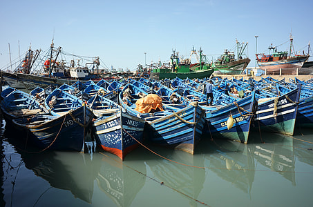 blue boats on calm body of water thumbnail