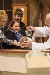 priest baptizing baby thumbnail