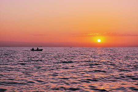 two person sailing on boat under sunset thumbnail