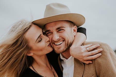 woman kissing smiling man at daytime thumbnail