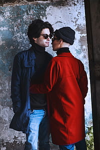 two person beside gray wall thumbnail