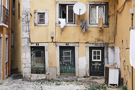 White Parabolic Antenna Beside Brown Concrete Building thumbnail