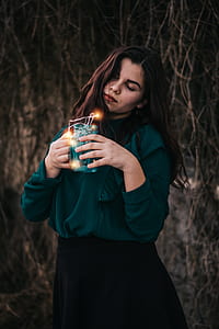 woman holding mason jar with string lights thumbnail
