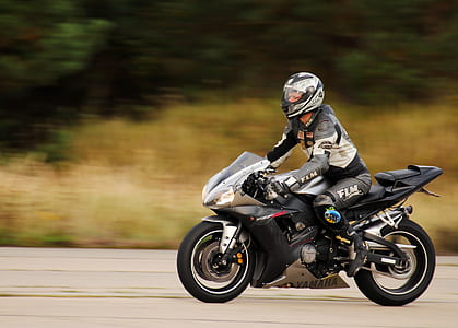 man riding gray sports bike thumbnail