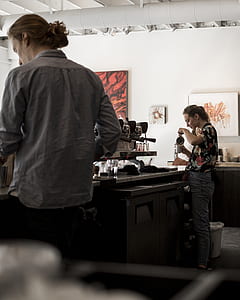 woman making coffee in front of espresso machine thumbnail