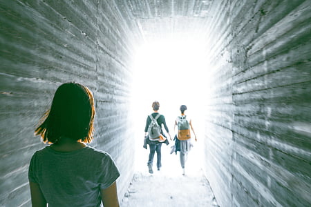 woman walking behind two couple thumbnail