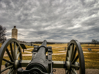 black metal cannon pointing near grey concrete stand during dark time thumbnail