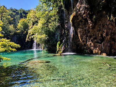 landscape photography of waterfalls surrounded by body of water thumbnail