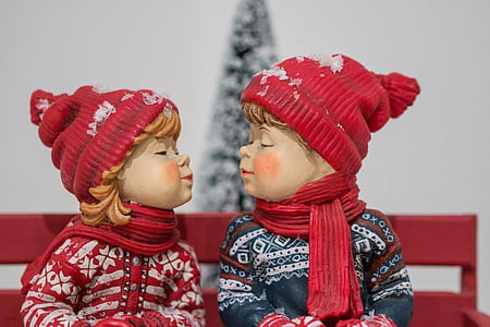 boy and girl wearing hat facing each other figurine thumbnail