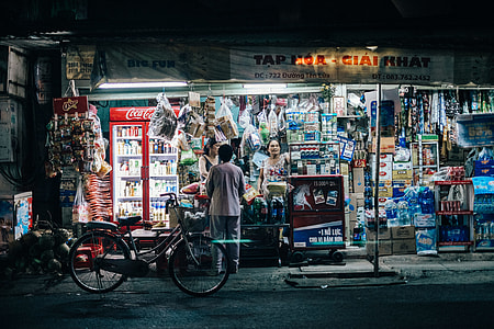 woman standing near the bicycle buying on the store thumbnail