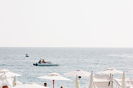 white motor boat on body of water thumbnail