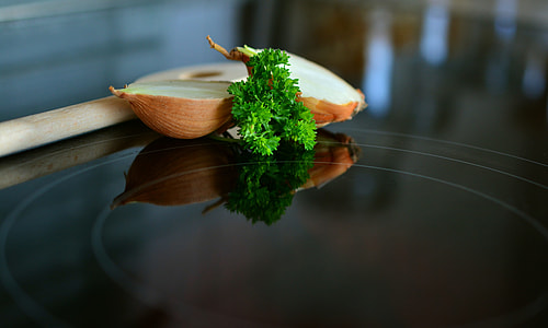 selective-focus photography of sliced onion and green parsley on black surface thumbnail