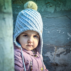 girl wearing knit cap and purple jacket thumbnail