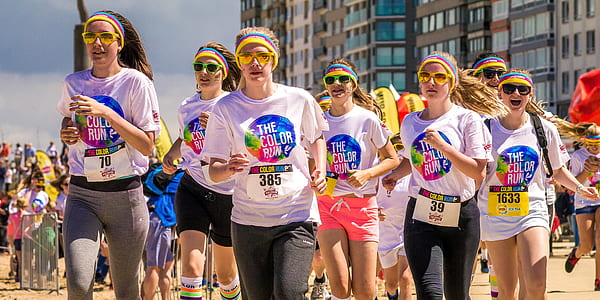 group of people running wearing The Color Run shirts thumbnail