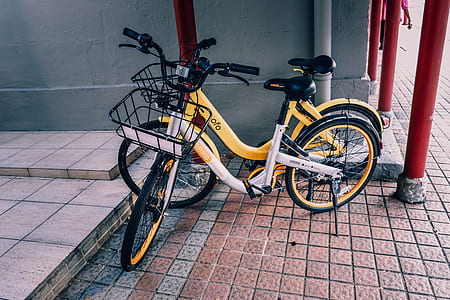 two white and yellow step-through bicycles on floro thumbnail