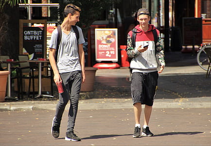 two man standing on street road duringdaytime thumbnail