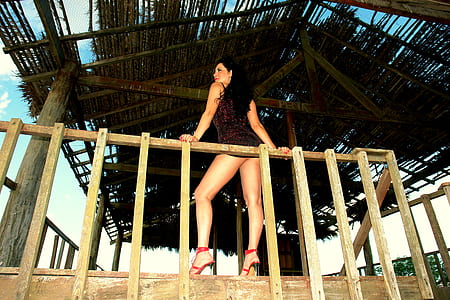 woman leaning on wooden handrails thumbnail
