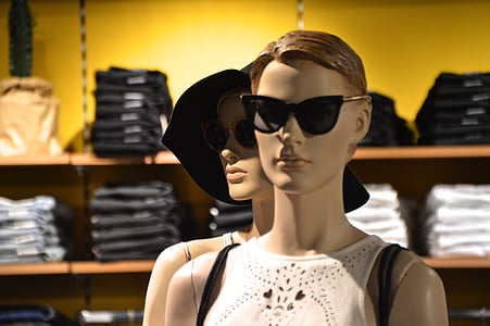 two woman mannequin wearing white sleeveless shirt in room thumbnail