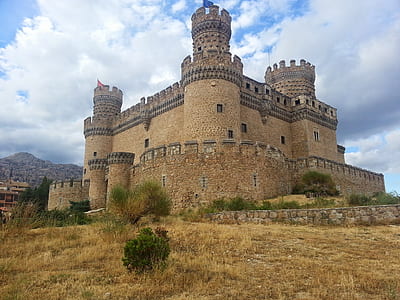 brown concrete castle under cloudy blue sky thumbnail