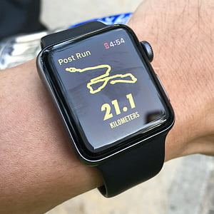 person wearing space gray Apple Watch with black Sport Band displaying 21.1 kilometers thumbnail