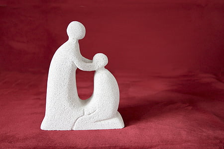 standing human and kneeling human figurine on red textile thumbnail