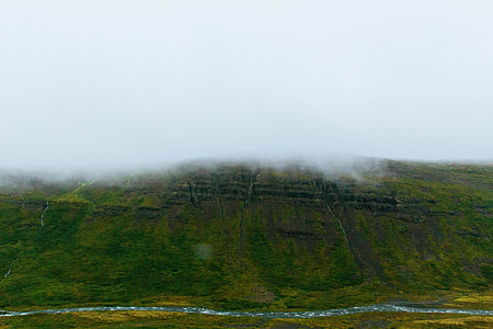 road beside mountain during day thumbnail