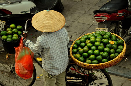 person pushing bike with baskets thumbnail